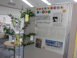 パネル展で「じぶんの『やりたい』をたいせつに」と題した作品が展示され、その横の笹に願いを書いた短冊が飾られているパネルの写真
