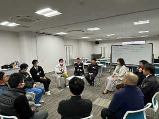 講義のあと、室内で参加者たちが輪になり、哲学対話の体験をしている写真