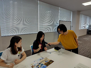 参加者が講師の持つマイクを使って、意見を発表している写真