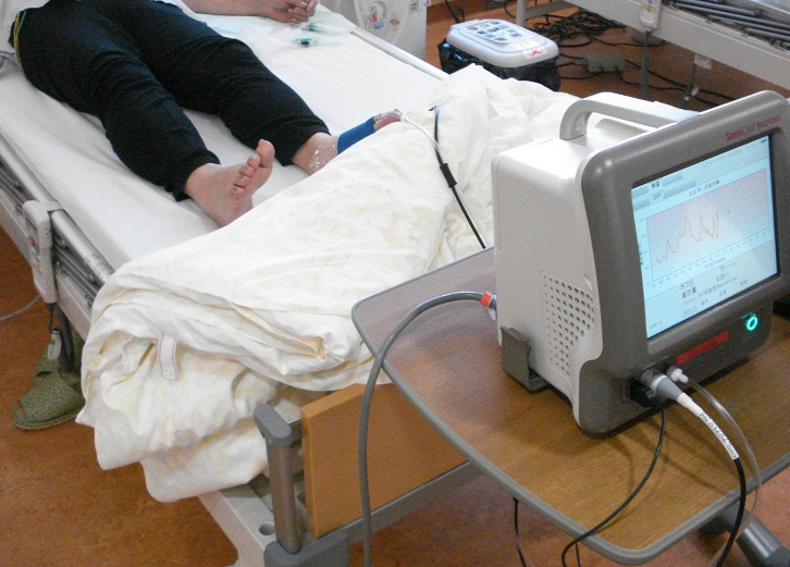 横になった人の足につながった機材のモニターの写真