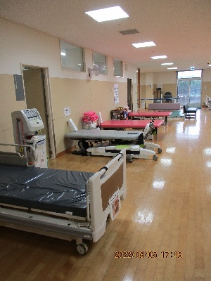 寝転がれる器具が数台置いてあるフローリングの部屋の写真