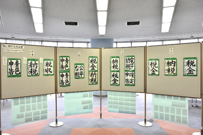 展示パネルに習字が貼られている写真