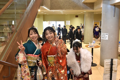 階段で振り袖姿の女性二人がピースサインしている写真