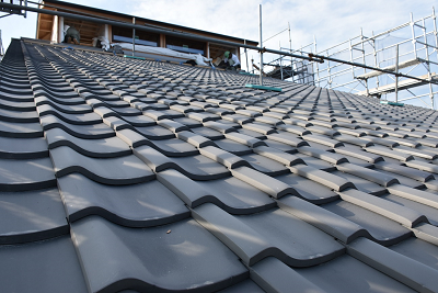 灰色の瓦屋根が一面に葺かれ見上げる構図で撮影された写真