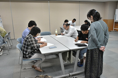 紙に書き込んでいる参加者達の写真