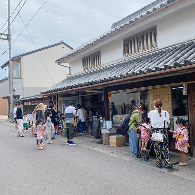 瓦屋根の建物に集まる親子達の写真