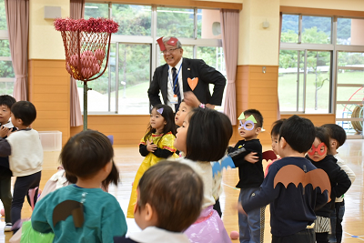 志度幼稚園の遊戯室で13名の園児が市長と玉入れをしている写真